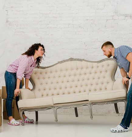 Couple moving sofa