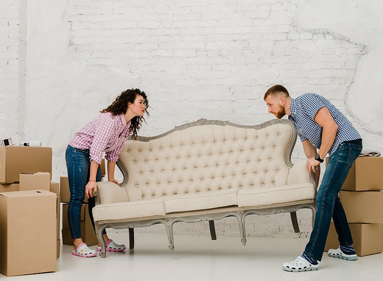 Couple moving sofa